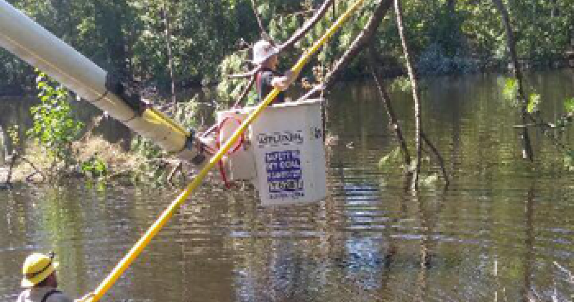 Lineworkers near the town of Coward face water challenges as they work to restore power.